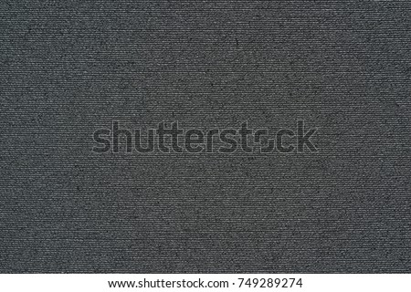 abstract macro texture of damp synthetic fabric for a background of dark black color