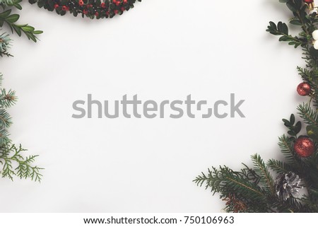 top view of christmas frame made of fir branches, christmas balls and pine cones, isolated on white