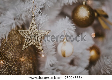decorating christmas tree at home. Ornament close up on background of christmas tree with colorful lights and toys, copy space for text