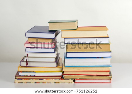 Piles of books in a flat style, on the table in studio against white background. Stack of books with bookmarks. Concept of learning. 
