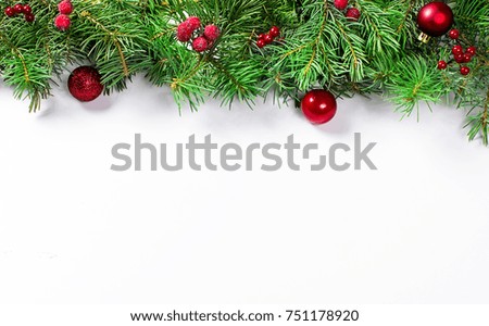 decorative background with fir branches, frozen berries and red balls on the white . Christmas card Holiday Concept. copy space, top view.