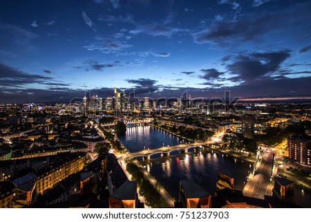Aerial view over the City of Frankfurt at night with the river Main in the foreground and the skyline (Commerzbank, Main Tower) in the background