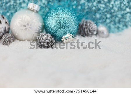 Christmas baubles on snow as background in winter 