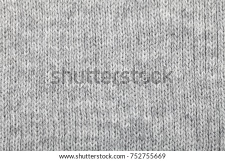 Grey knitted fabric made of heathered yarn textured background