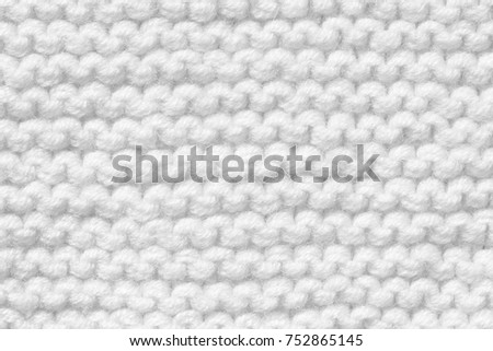 Texture of white knitted handmade. Background for various purposes.