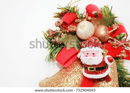 Christmas Background Decoration with Santa Claus Figurine and New Year Celebration Symbols: Bells, Ribbon & Fir Tree Branch. Glittering decorative postcard with empty copy space for greeting postcard