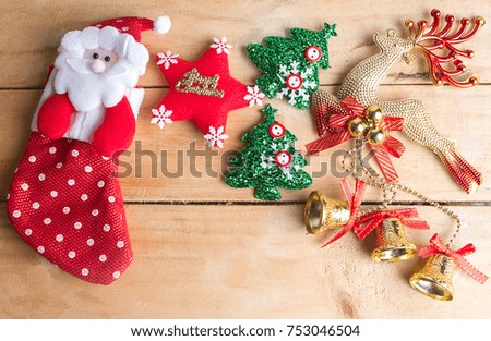 Santa's  stocking, red star, Golden deer with bell and Christmas tree on wooden floor