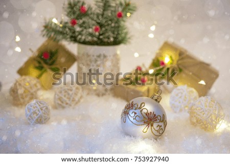 New Year's decoration ball on snow background with presents. Christmas card