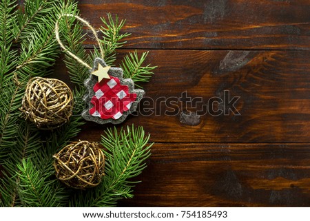 Christmas background. Christmas tree on the wooden background with hand made decoration.