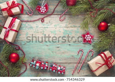 Christmas background with pine branches and decorations on old wooden table. Holidays background. Space for text or design. Top view.