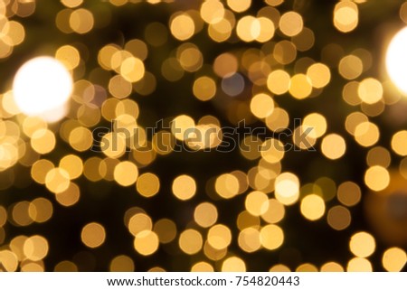 Abstract Christmas gold bokeh lights background with place for text. Beautiful Festive textured background. Vintage defocused background