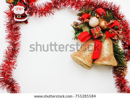 Christmas Background Card with Santa Claus Figurine Toy, Golden Jingle Bells and Red Festive Frame. Celebrating Winter Holidays Concept. Empty White Copy Space in the Center, Top View Image.