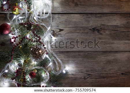 Christmas tree garland glows on an old wooden table, Christmas background