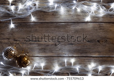Christmas tree garland glows on an old wooden table, Christmas background