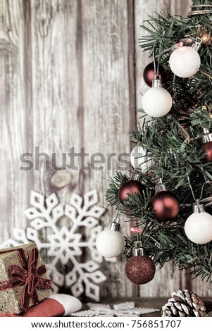 xmas tree and gift against old wooden planks