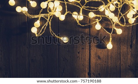 Christmas lights over wooden planks