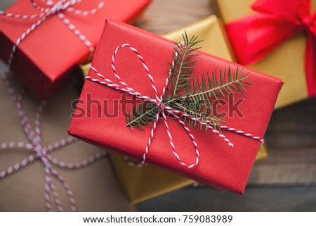 Christmas background with gift boxes on wooden background. Top view. Beautifully packaged multi-colored gifts for the new year or the day of the holy valentine.