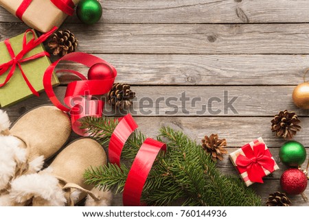 Christmas gifts, Christmas tree branch, Christmas decorations and children's winter boots.