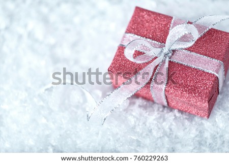 Red christmas nice gift on snowing background, cozy white celebration and happy gift box 
