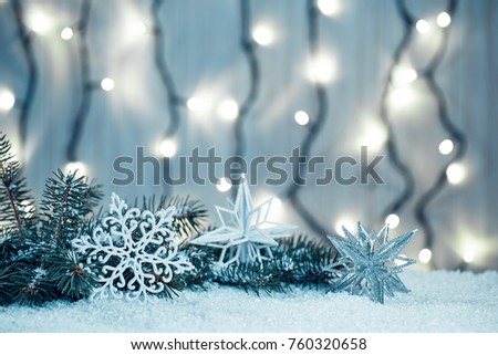 Christmas background with garland, Christmas tree branches, snow and decorations on wooden table