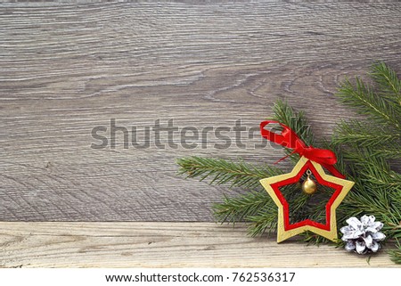 Fir branches and Christmas star on wooden background. Space for text. 
