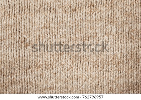 beige woolen knitted fabric close-up