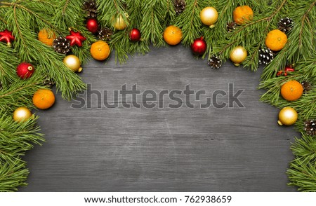 Christmas decoration, garland frame concept background, top view with copy space on black wood table surface. Christmas ornaments.
