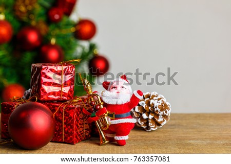 Santa Claus dolls and Christmas decorations box on the old wooden table with copy space