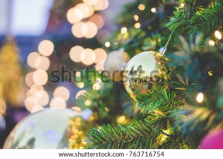 Christmas background of de-focused lights with decorated tree.