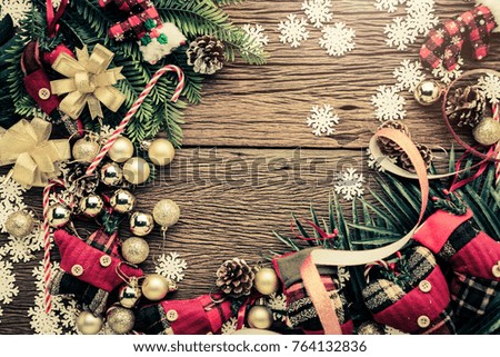 festive background concept with christmas decorating items on wooden background with light filter