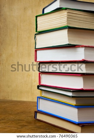 pile of new and old books on wood texture