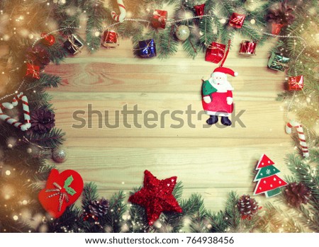 christmas background and decoration with fir branches snow on wooden board