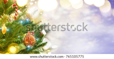 christmas evergreen fresh tree with holiday decorations and lights with copy space on magic bokeh background, toned