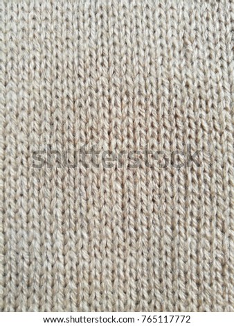 Background of knitted fabric texture with beige color.