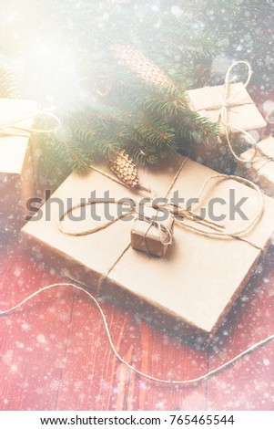 Christmas composition New Year gifts fir tree pine cone roap on red wooden table maribee with glow light and snowflakes