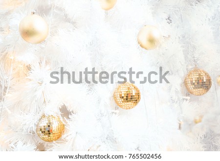 Golden ball on white Christmas tree background, white snow tree in winter at Xmas festival