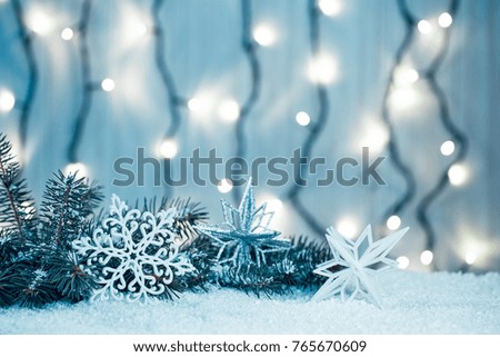 Christmas background with garland, Christmas tree branches, snow and decorations on wooden table