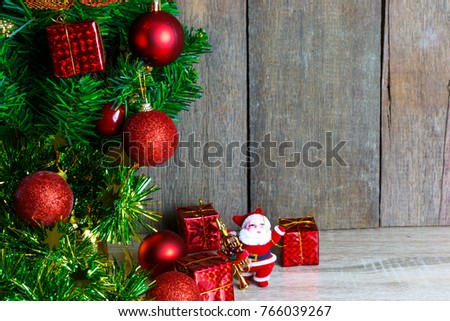 Santa Claus dolls and Christmas decorations box on the old wooden table with copy space