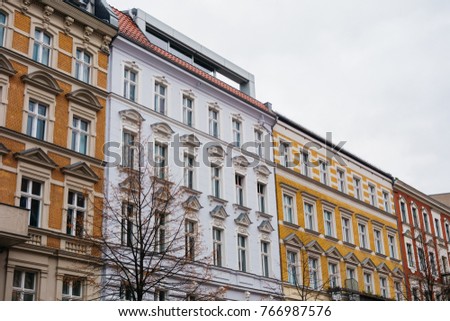 Colorful facades of tenement buildings in low angle view