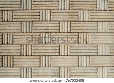 Old concrete wall with rectangular and square decorative geometric pattern 