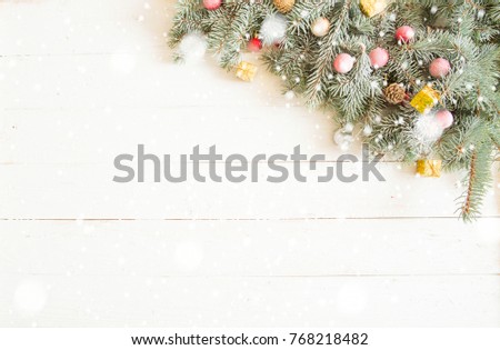 Christmas gift box and fir tree branch on wooden table. Top view with copy space.