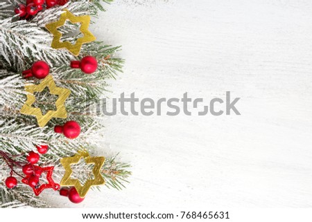 Fir branch with Christmas decorations on old wooden shabby background with copy space for text