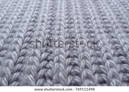 knitted scarf made of woolen natural thread, textile fabric for close-up design