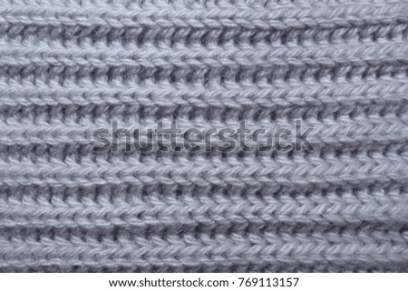knitted scarf of woolen threads close-up knitted fabric clothing warm clothes handmade textile natural materials wallpaper background texture