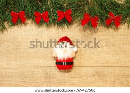 New Year / Christmas tree with red bows, Santa toy on the wooden background template