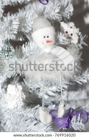Toy of a snowman on a Christmas tree