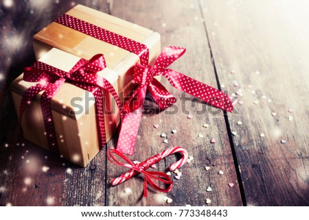 Christmas presents with holidays dacoretions on wooden background in vintage style