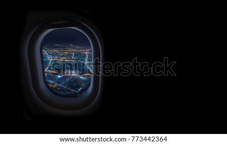 night cityscape from airplane window in the sky with dark place for text, travel and tourism concept