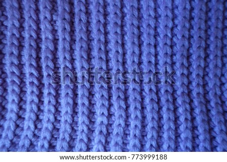 Handmade violet knitted textile with vertical ribbing pattern