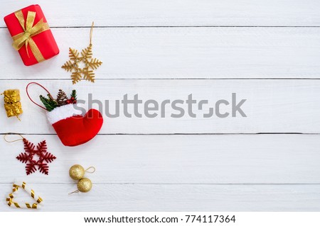 Christmas Background.  Christmas gif boxes, snow flake, red sock, christmas ball and candy cane on white wooden board. Creative Flat layout and top view composition 